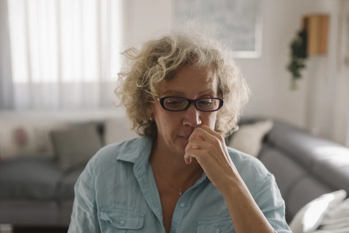 A person focused on a laptop while working at home